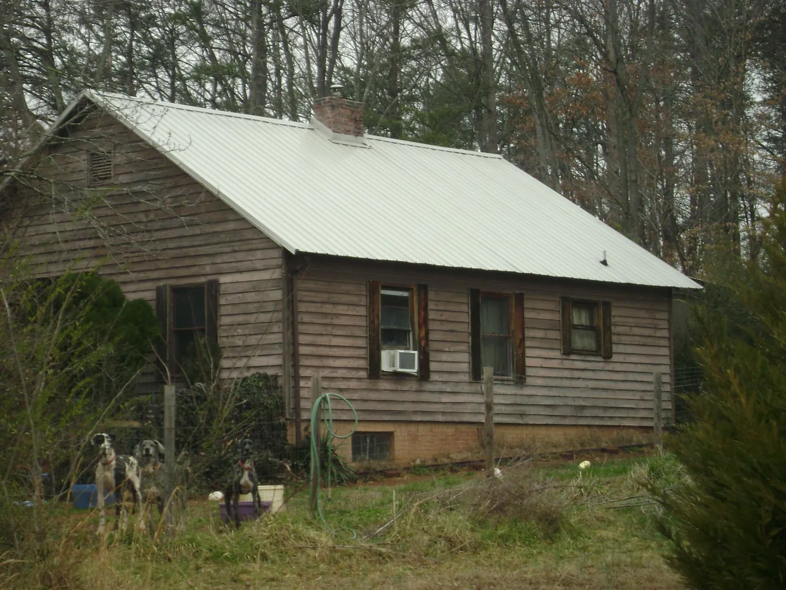 White metal roof on an old wood sided farmhouse, from a Metal Roof Installation job in Brookville